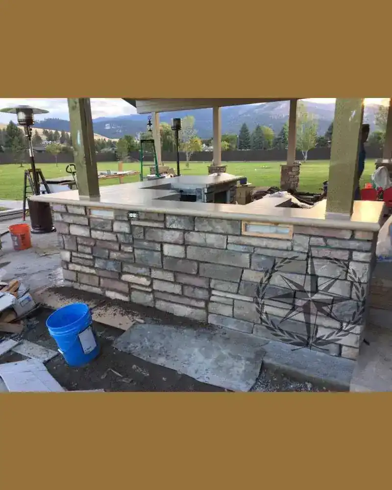 Laying up the stone face of the outdoor bar wall
