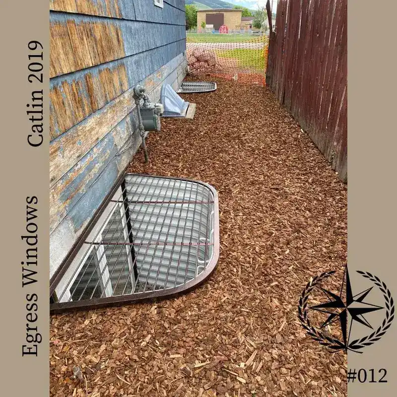 The side yard restored with bark mulch over the completed wells