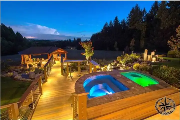 Deck, pool and pergola lit at night