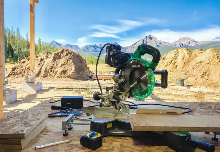 Miter saw set up on a jobsite below the mountains